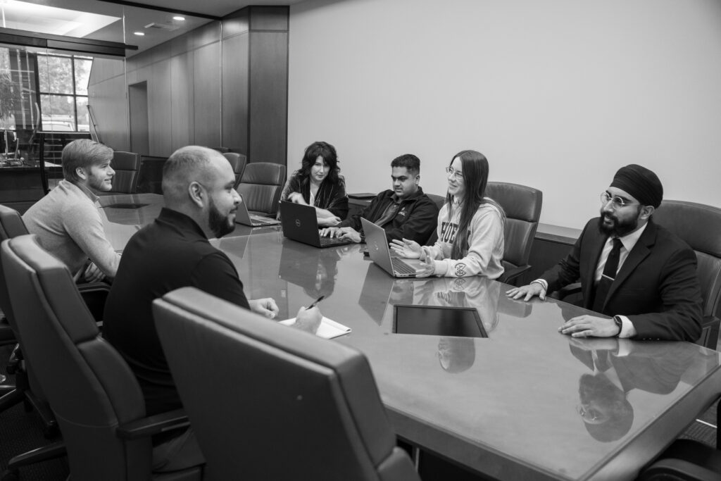 people sitting at a table having a meeting.