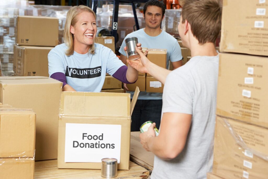 3 people with food donation boxes